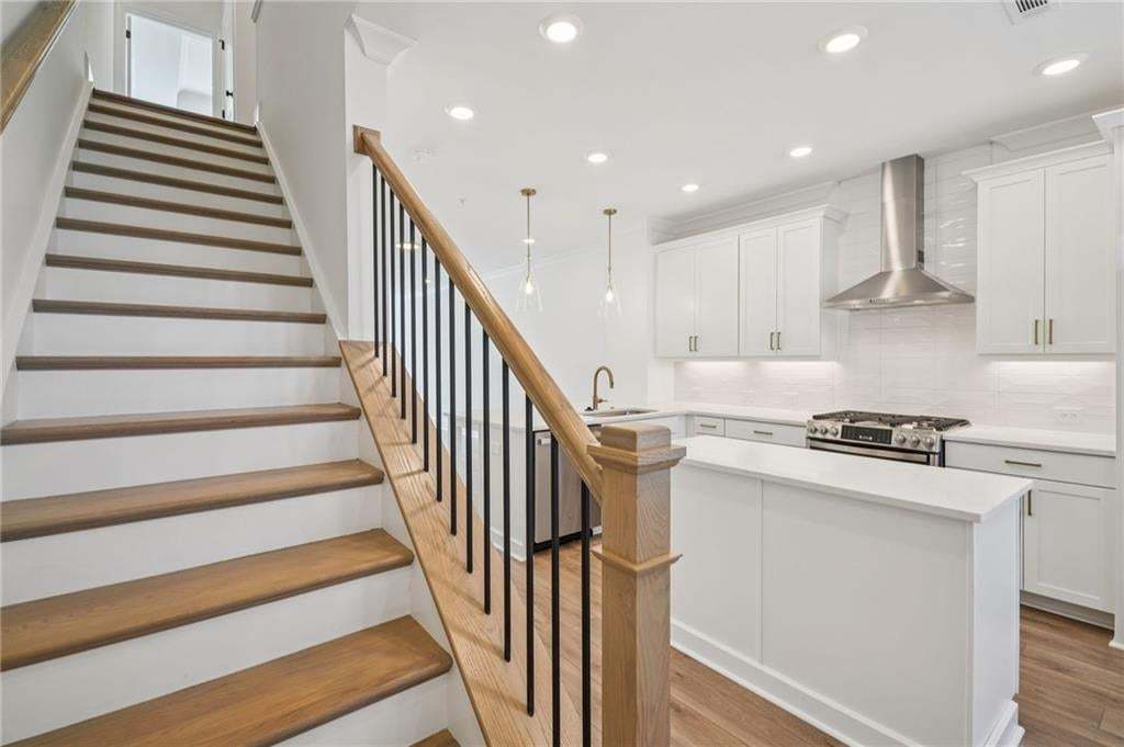 Stairs on second floor leading to 2 bedrooms on upper level.