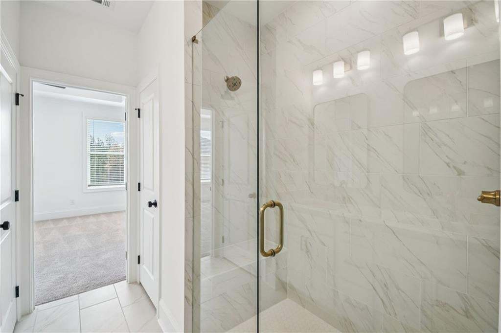 Frameless shower with tile surround.