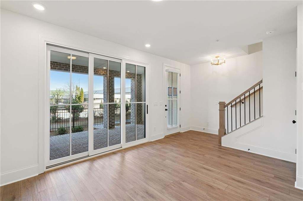 Terrace level bonus room with sliding glass doors, leading to covered patio. Perfect for entertaining!