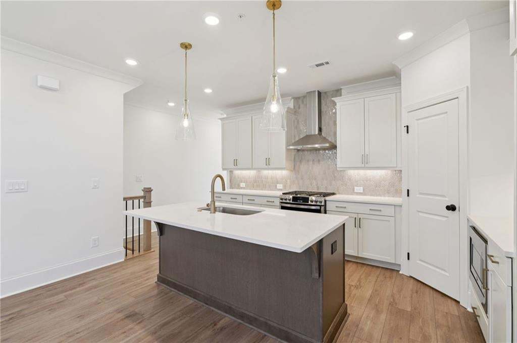 Brushed Gold pendant lights above large kitchen island.