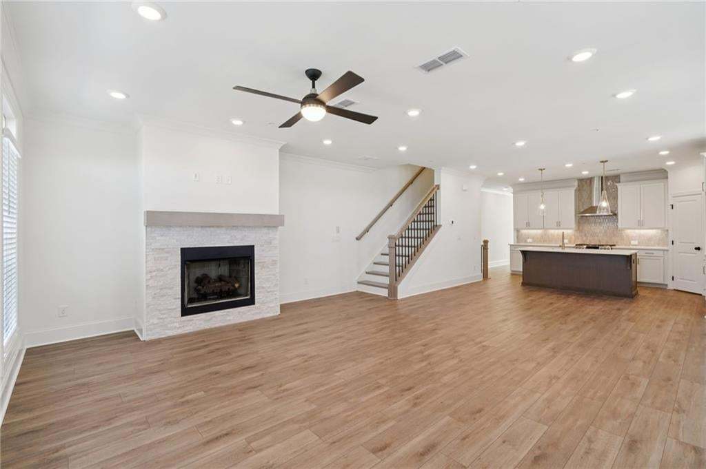 Open concept living/dining. Gas Fireplace with Stacked Stone surround.