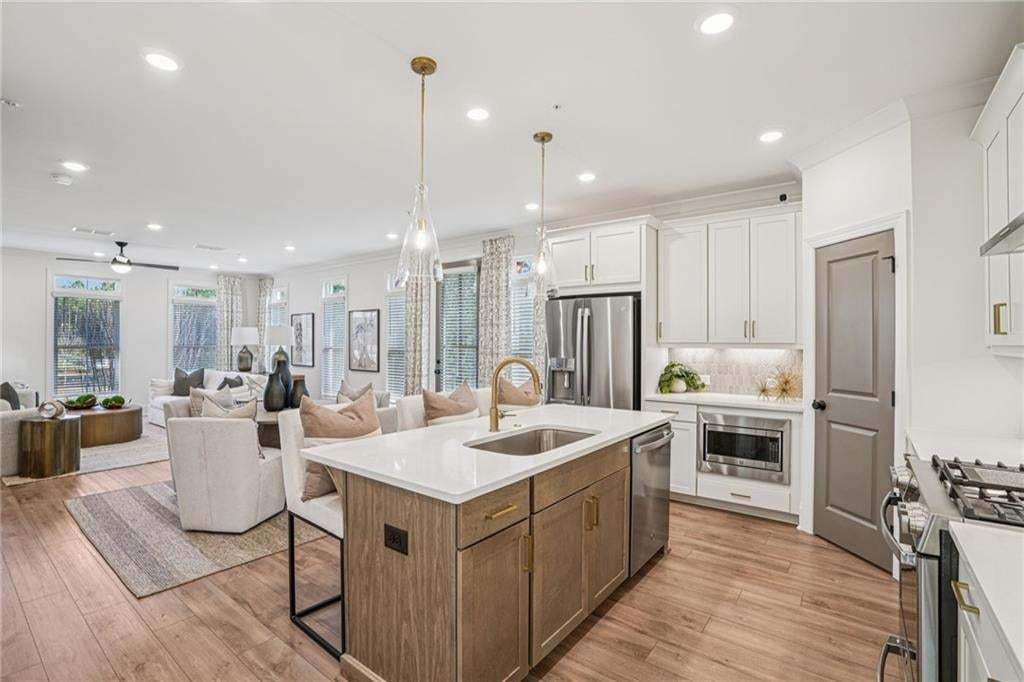 Quartz countertops , Gold Package faucets . Refrigerator , blinds not included .Not the actual building or unit