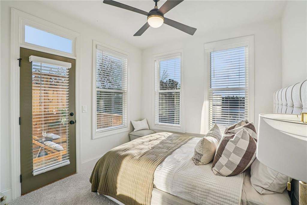 Guest Bedroom with a door to a upper wooden deck not the actual unit or building