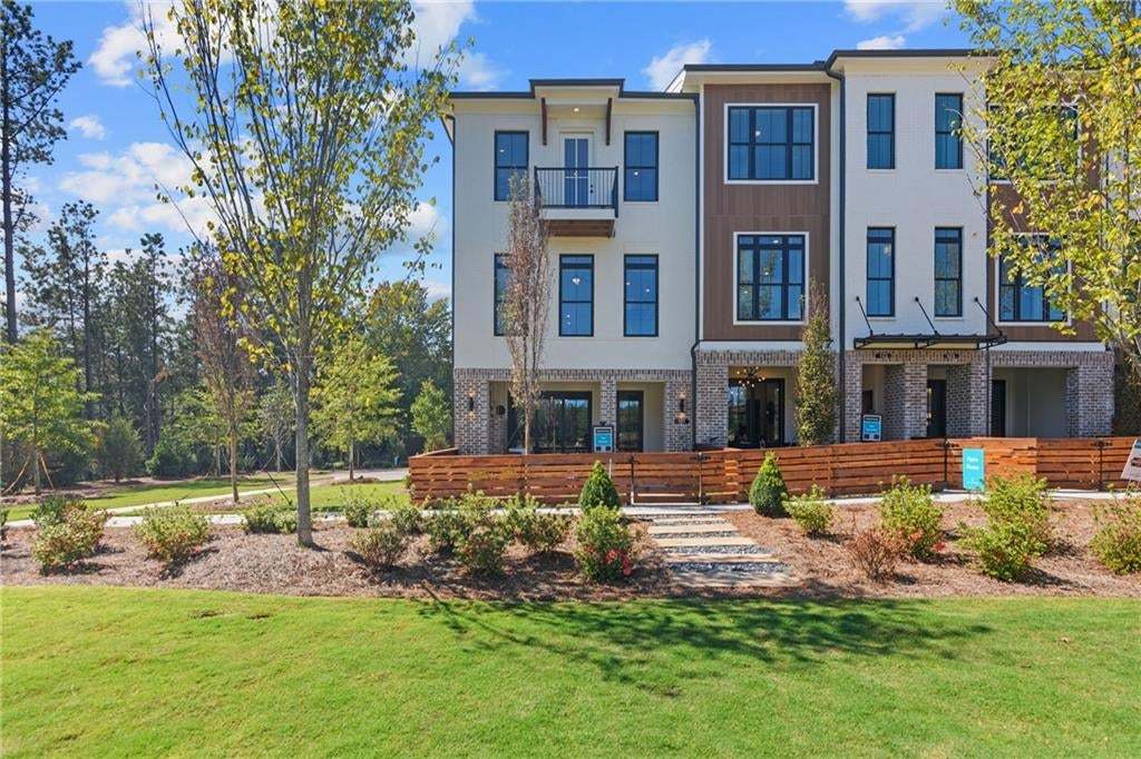 Front of Structure - Photo of completed building at IveyBrooke. Front entry townhome, with private front yard. *Not the actual unit but photo is similar to the exterior.