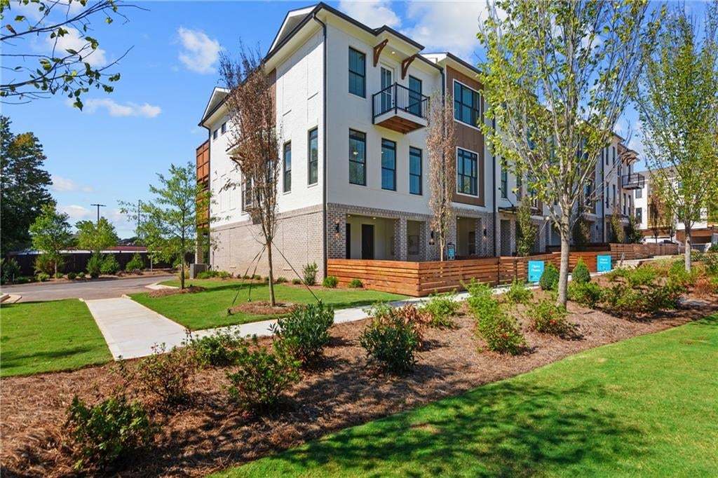 Front of Structure - Front entry with private yard and wooden fence. *Not the actual unit but photo does represent the exterior.Other - Bonus Room with sliding glass doors leading to covered patio. *Photos are not the actual unit. Decorated model home