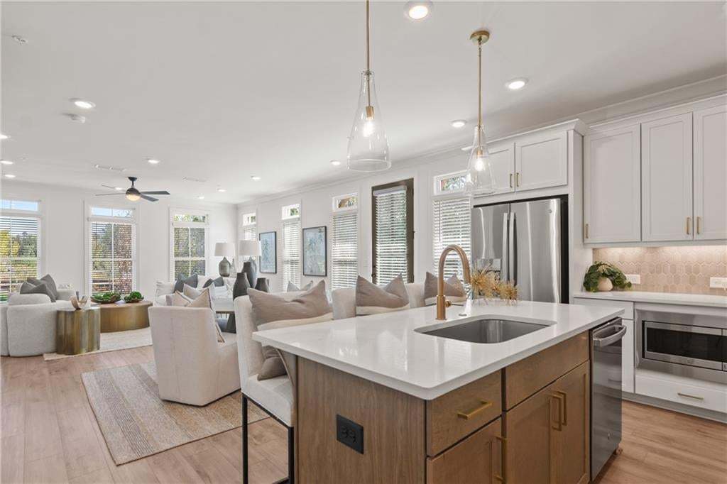View from kitchen leading to dining/living room. *Photos are not the actual unit. Decorated model home photos used.