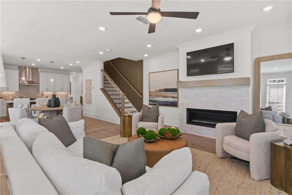 View from the living room leading to dining area and kitchen. *Photos are not the actual unit. Decorated model home photos used.