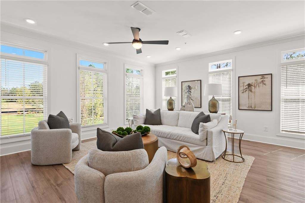 End unit living room with plenty of natural light. *Photos are not the actual unit. Decorated model home photos used.