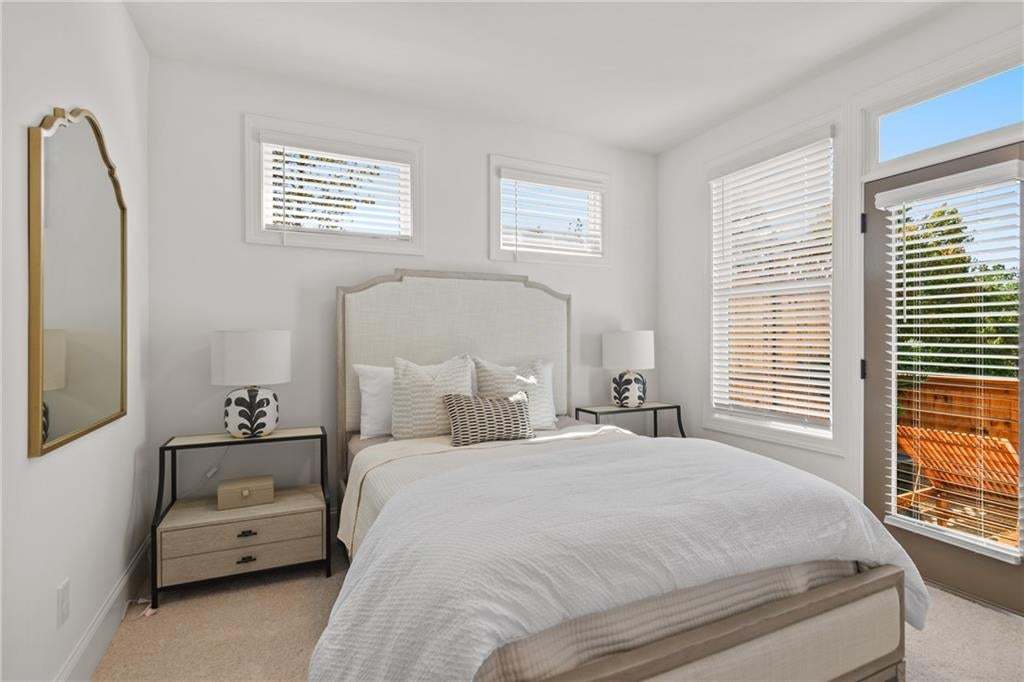 Guest bedroom 2 opens to private wooden deck. *Photos are not the actual unit. Decorated model home photos used.