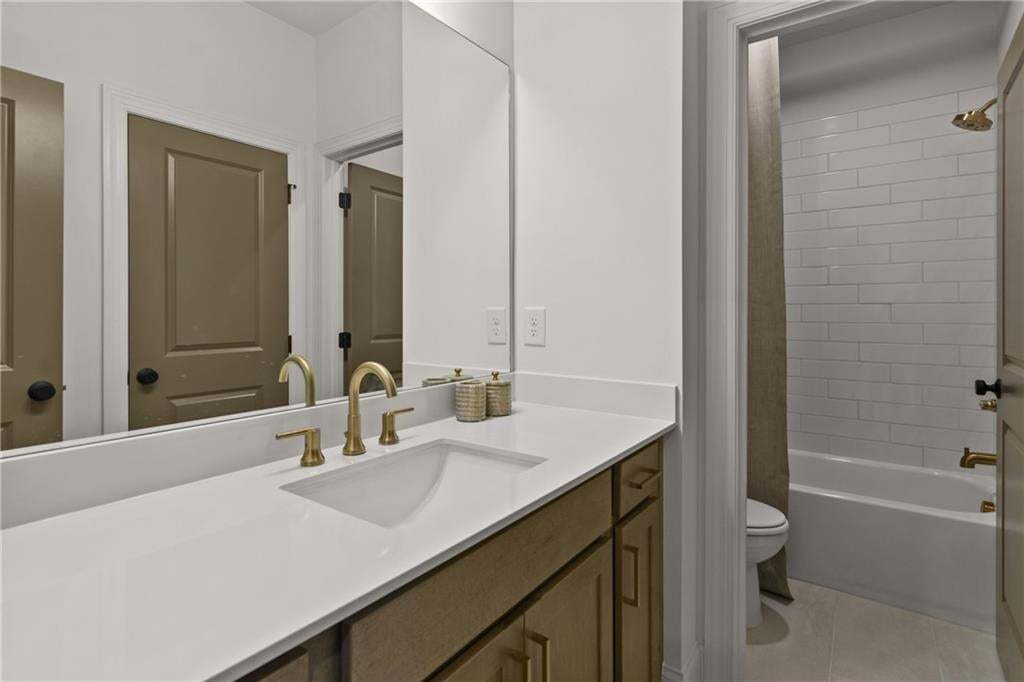Guest bathroom located on third floor. Opens to secondary bedroom 2. *Photos are not the actual unit. Decorated model home photos used.