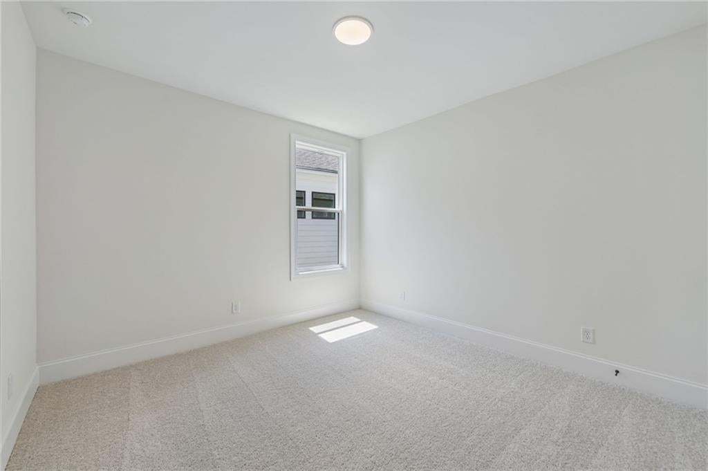 Neutral-toned room featuring a single window and recessed lighting