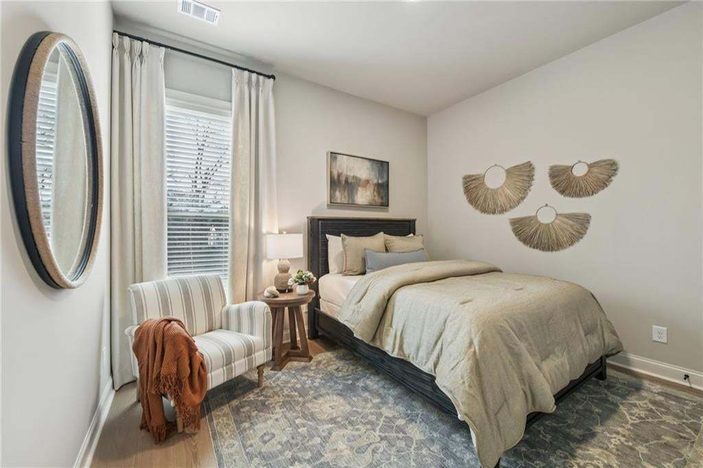 Secondary bedroom on main floor with full bathroom, perfect for guests. Photo not of actual home but for representation purposes only.
