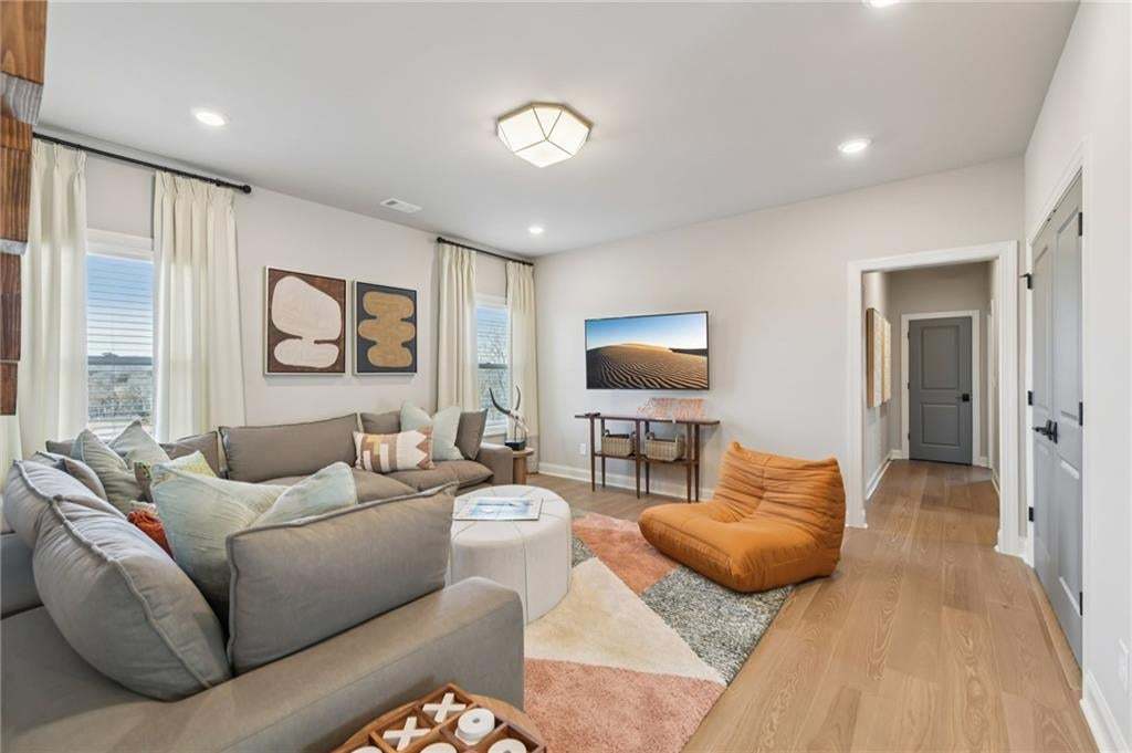 Loft area with hallway leading to secondary bedrooms. Photo not of actual home but for representation purposes only.