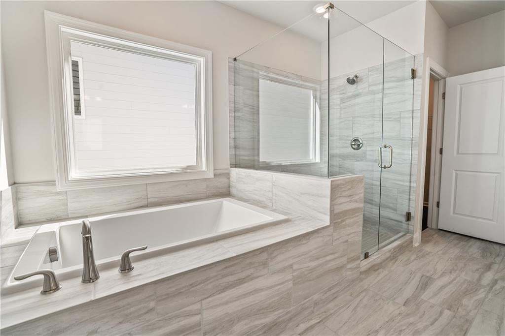 The spa-like primary bathroom.  Don't need a tub, we can install our walk-in shower with drying station. Photo not of actual home, but previously built TPG home.