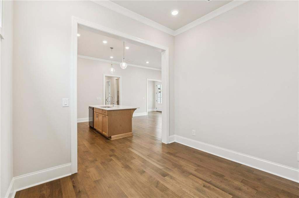 Spare room featuring ornamental molding, recessed lighting, and dark wood-type flooring
