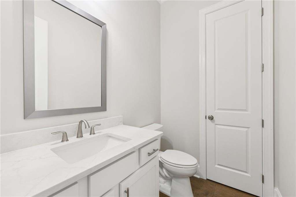 Bathroom with vanity and dark wood-style floors