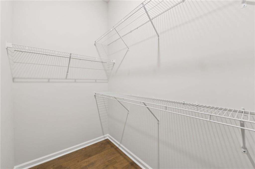 Walk in closet featuring dark wood-style flooring