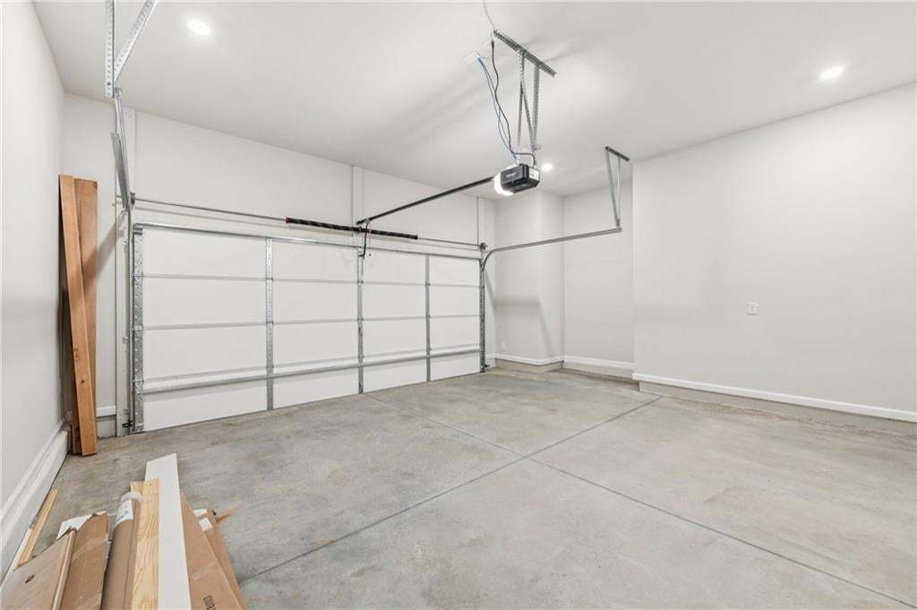 Garage with recessed lighting and a garage door opener