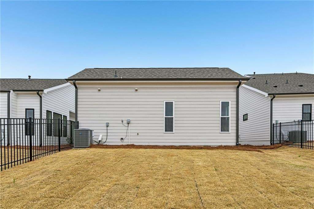 Back of property with a shingled roof