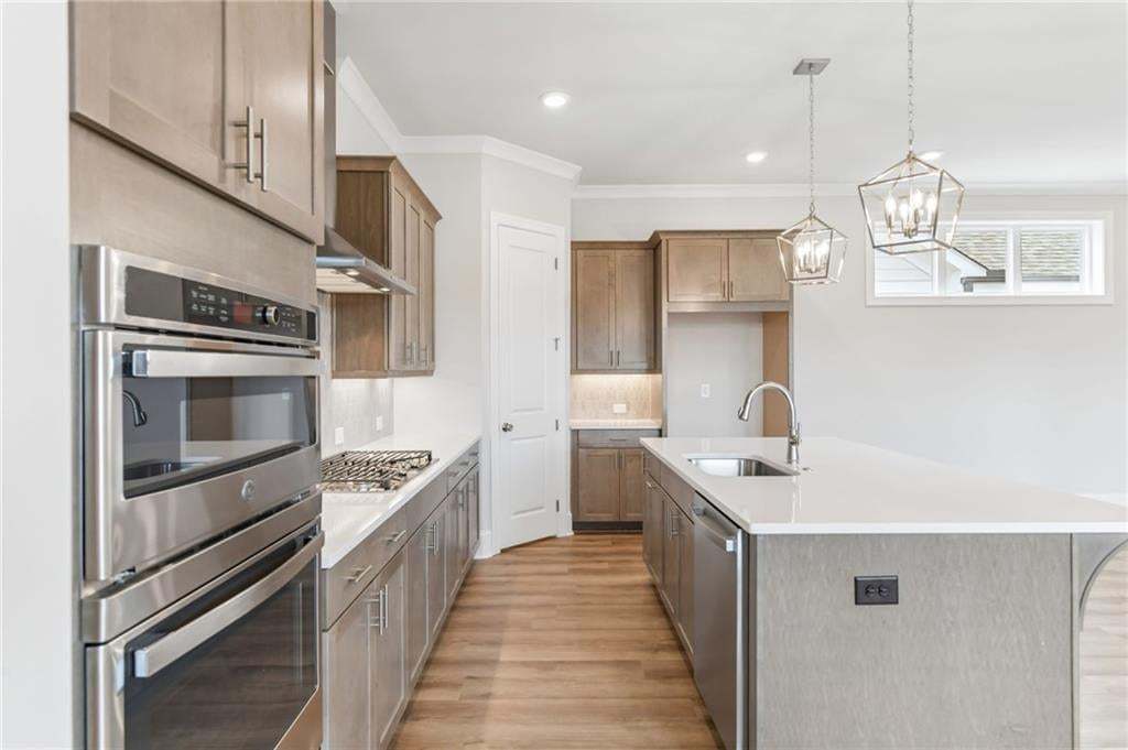 Gas top range, oven-microwave, under cabient ambient lighting, tons of light finish up this kitchen nicely!