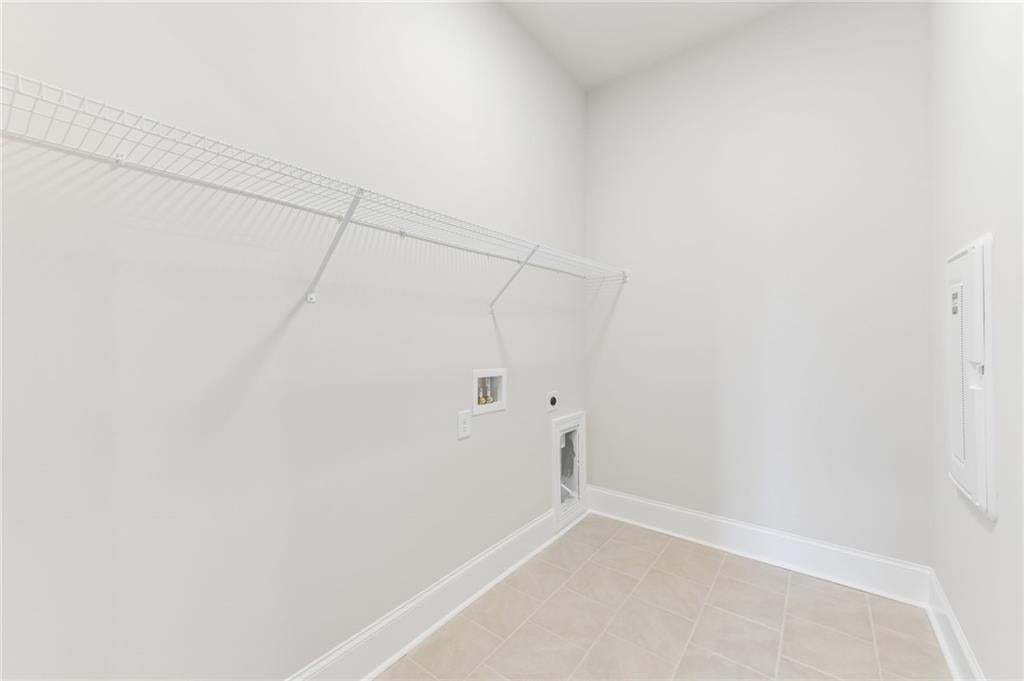 Oversized laundry room conveniently located near primary bedroom.