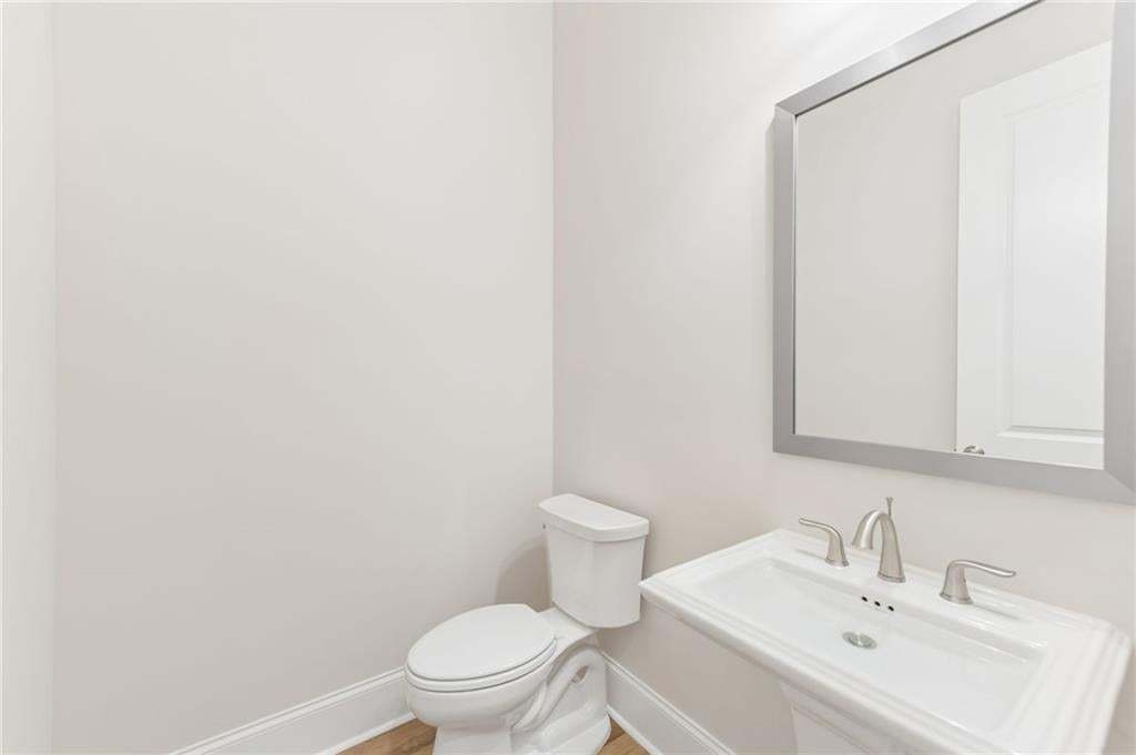 A powder room for guests in located near rear of home for extra privacy.