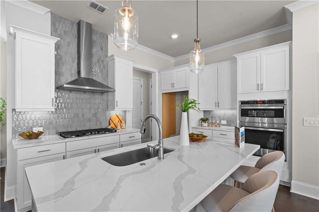 Beautiful cabinetry and quartz countertops are just some of the stunning features found in this home.