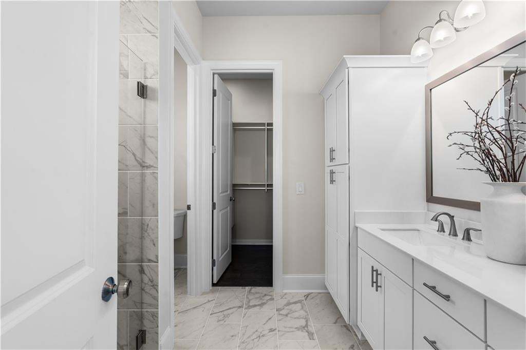 Primary bathroom with double vanities, large closet and oversized shower.