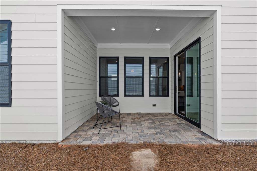 Hallway featuring dark wood-finish flooring, recessed lighting, and white trim