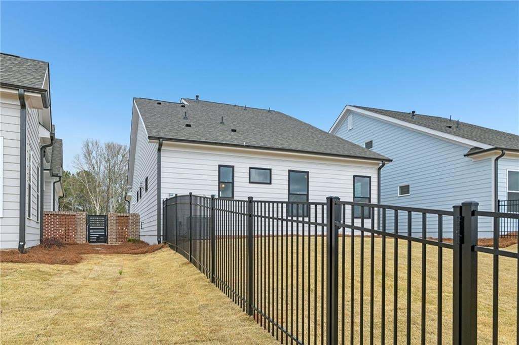 Rear view of property with a shingled roof