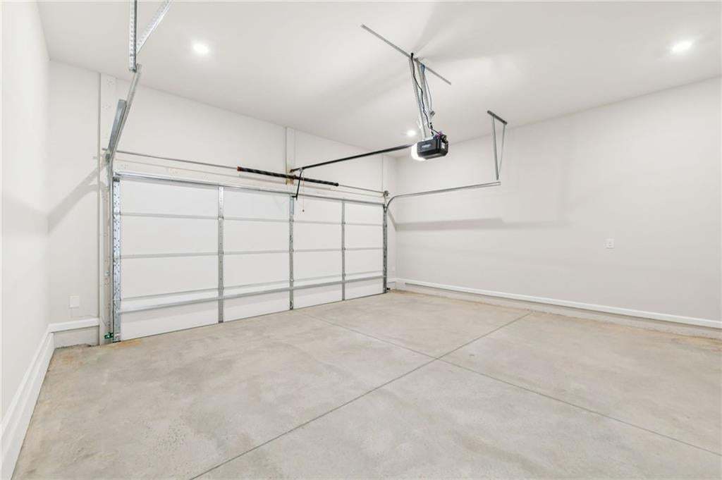 Garage with baseboards and a garage door opener