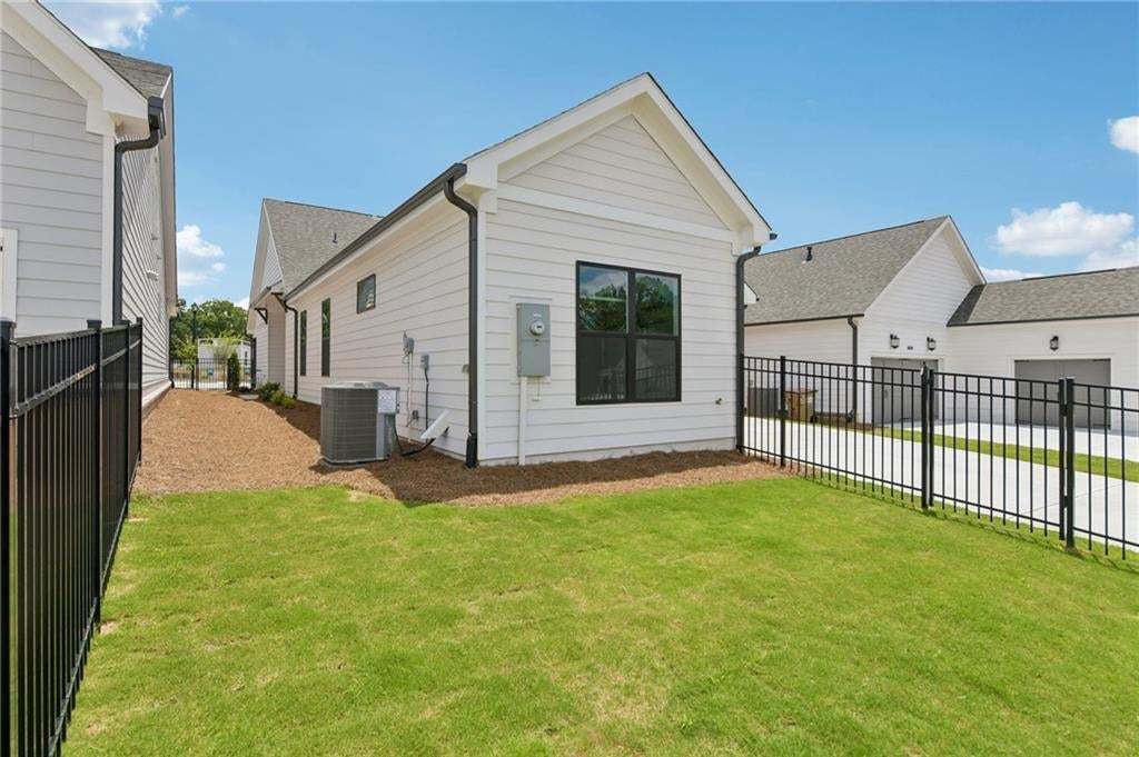 Manicured lawn area with black metal fencing