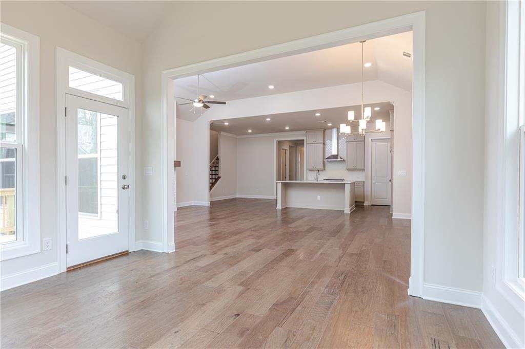 view from sunroom to living space and kitchen