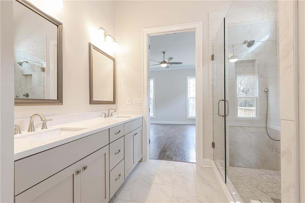Double vanity with undermount sinks, brushed nickel fixtures, and individual framed mirrors