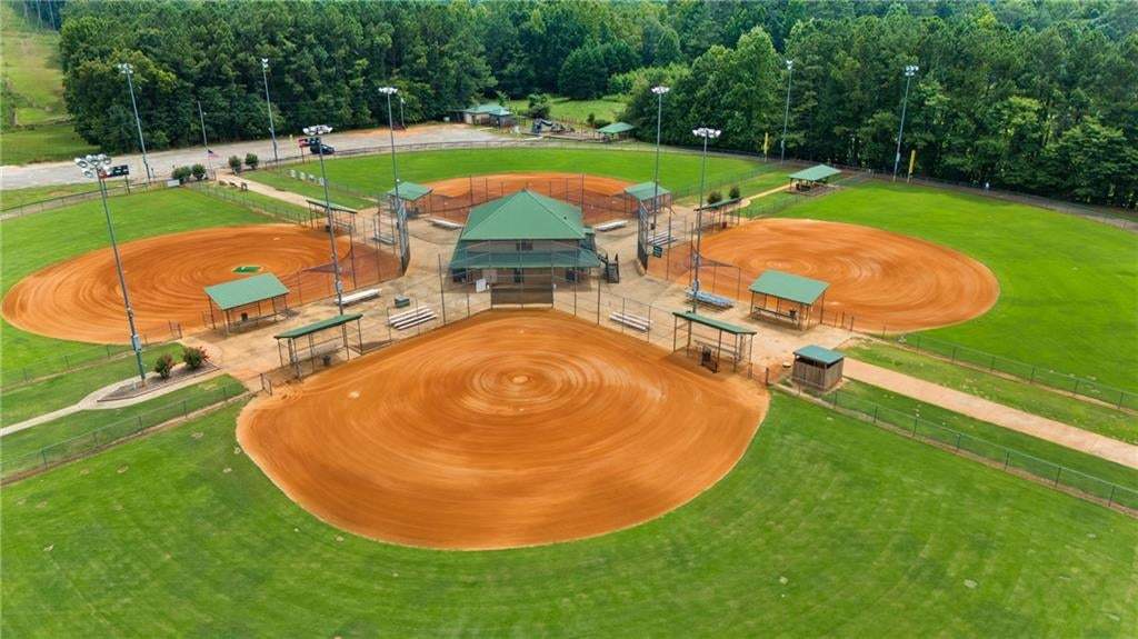 Recreational complex featuring multiple baseball fields with manicured outfields and red clay infields