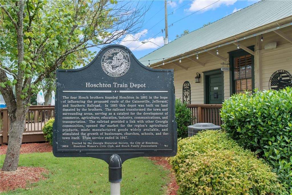 Black historical marker featuring white text