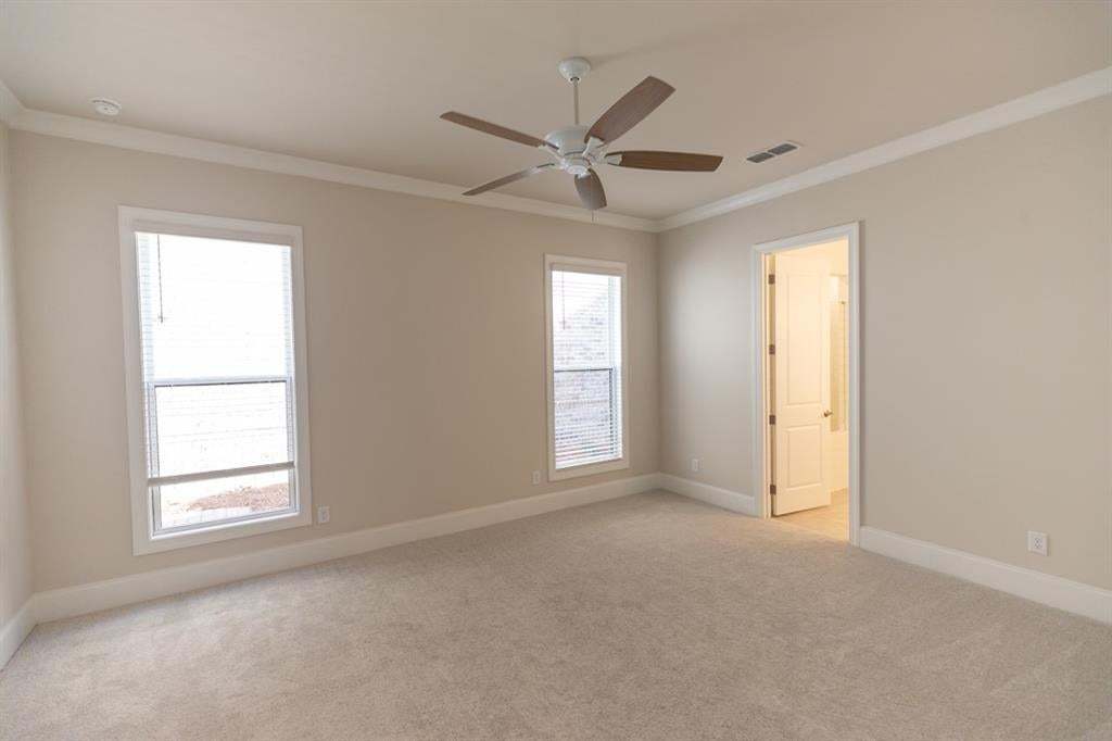 Large primary bedroom conveniently located on main floor.  You will appreciate the high 10-foot ceilings throughout the main floor.  8-foot solid doors.   Photo is for representation purposes only, not of actual home but a previously built home by The Pr