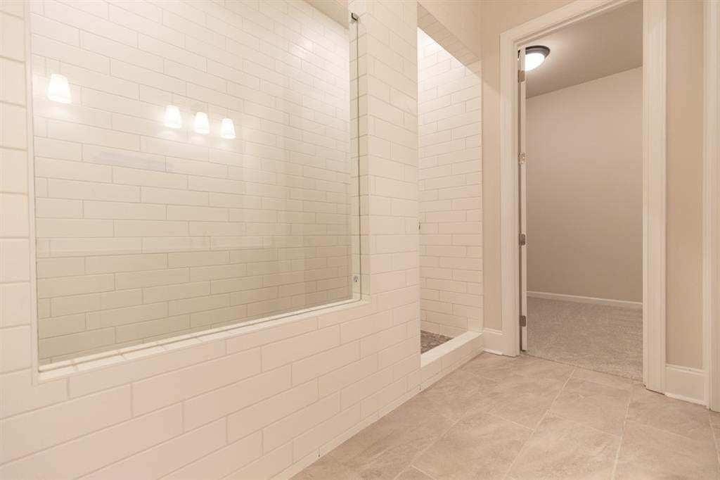 Walk in shower with drying station is just beautifully crafted with rain head shower, hand-held wand,. Photo is for representation purposes only, not of actual home but a previously built home by The Providence group.
