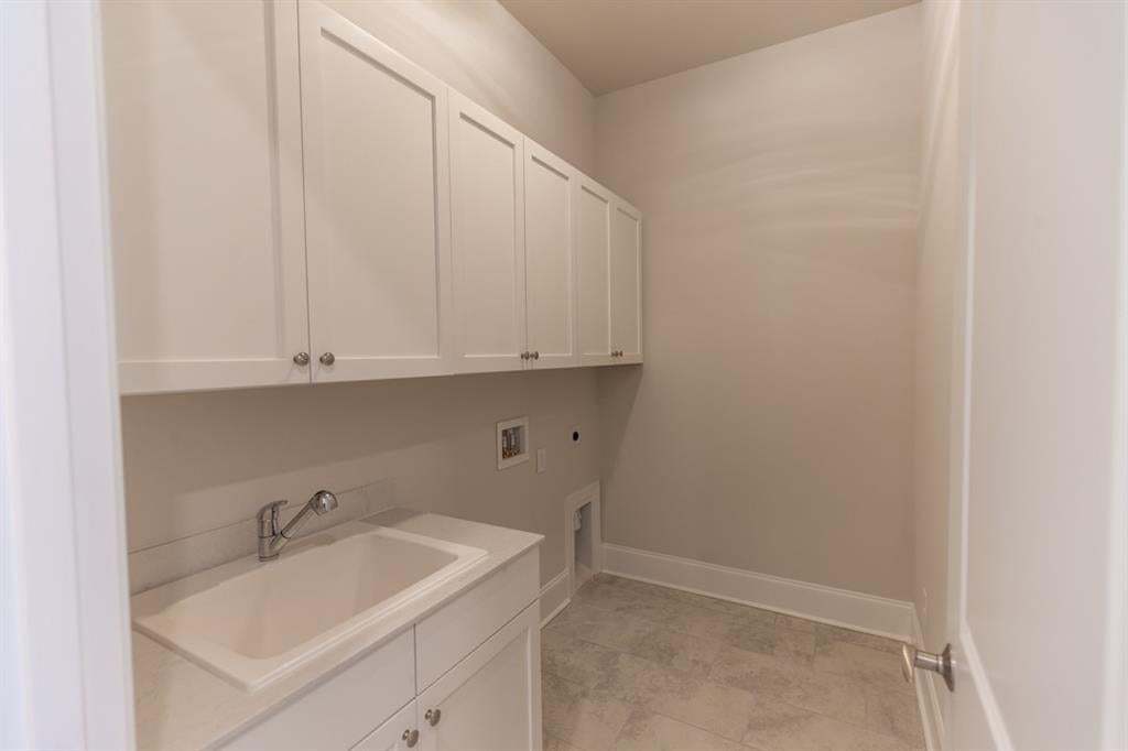 Spacious laundry room located on main floor.   Photo is for representation purposes only, not of actual home but a previously built home by The Providence group.