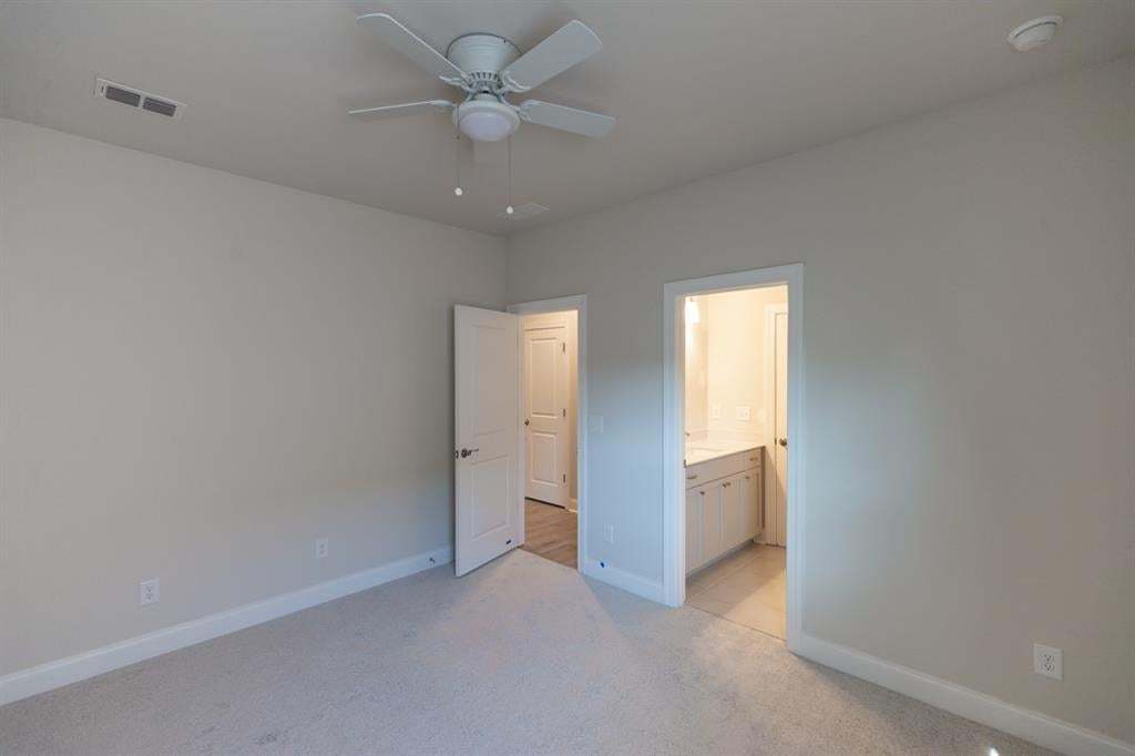 Neutral tone walls with carpeting, a ceiling fan, and white trim