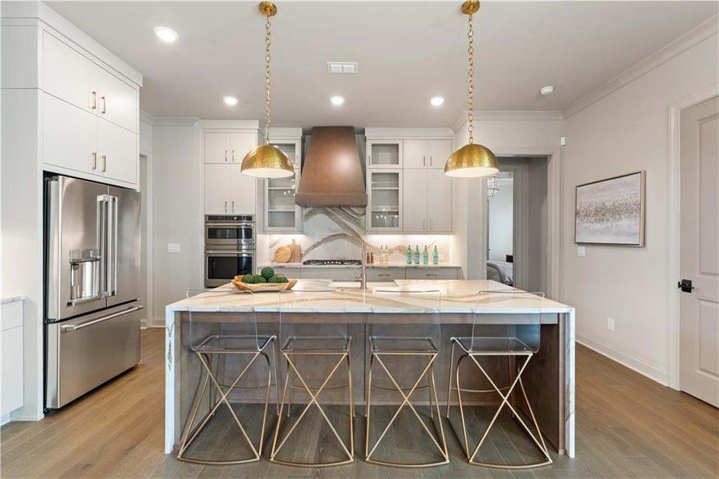 Love the space in the kitchen...large kitchen island is perfect for informal dining.  Photo not of actual home but for representation purposes only.