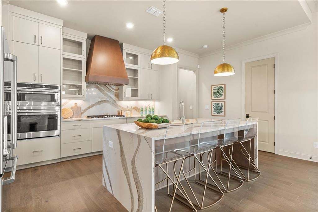Plenty of seating for informal dining at this massive, oversized kitchen island.  Photo not of actual home but for representation purposes only.