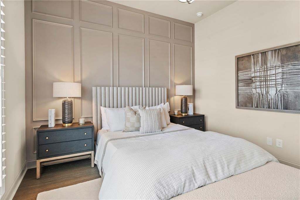 Accent wall featuring decorative panel molding in secondary bedroom. Photo not of actual home but for representation purposes only.