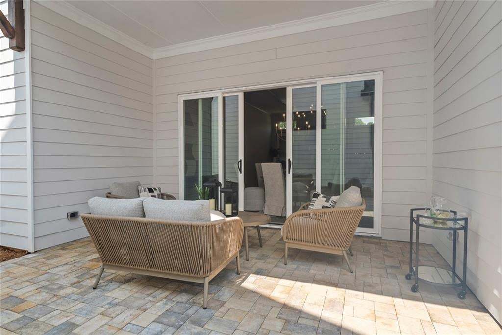 This patio space is perfect for relaxing after a long day, for coffee before the day gets started or for entertaining friends and family. Photo not of actual home but for representation purposes only.