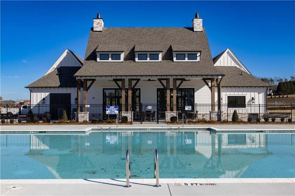 Large outdoor swimming pool with integrated steps and metal handrails