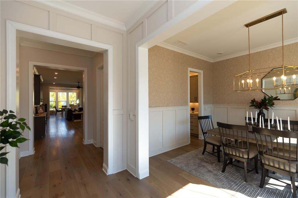 Wood-finish flooring throughout, board and batten wall details, and a decorative wall covering
