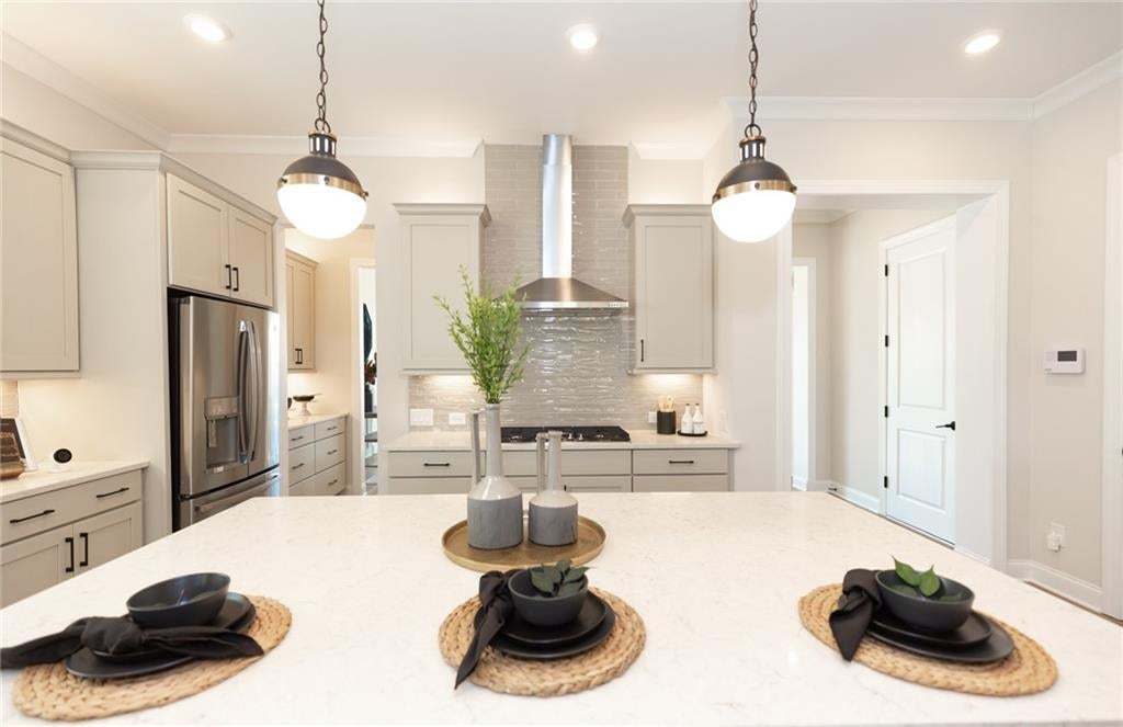 Plenty of space at the oversized island perfect for homework area, informal dining space, food prep and more! Photo not of actual home but of a previously built Madilyn by TPG.