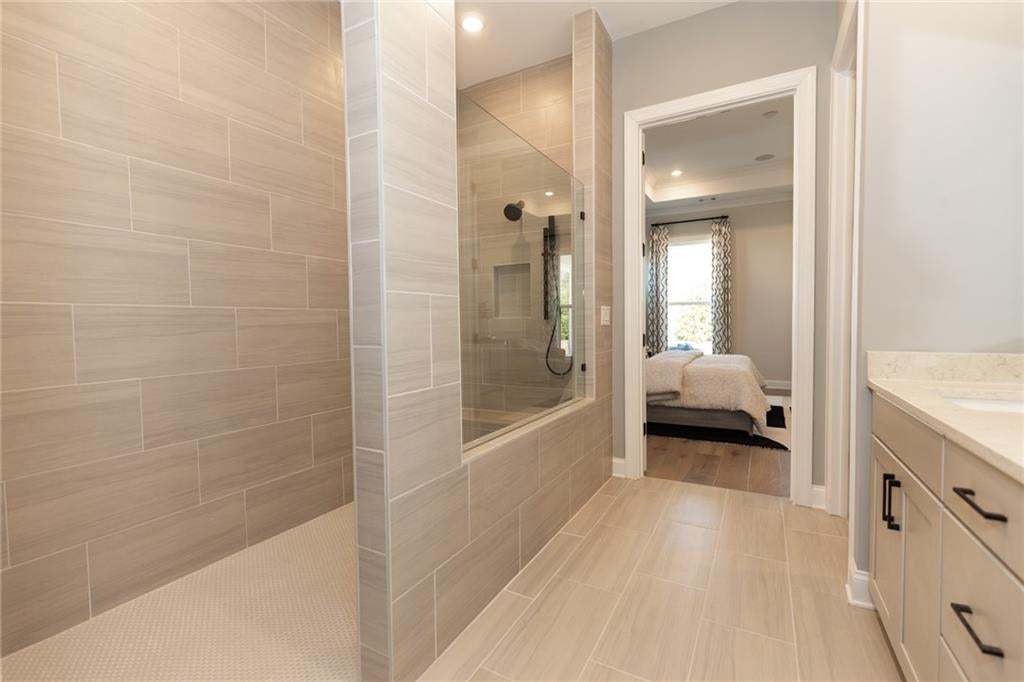 Walk-in shower with drying station is by far one of our buyers' favorite features in this stunning primary bathroom Photo not of actual home but a previously built Madilyn by The Providence Group. .