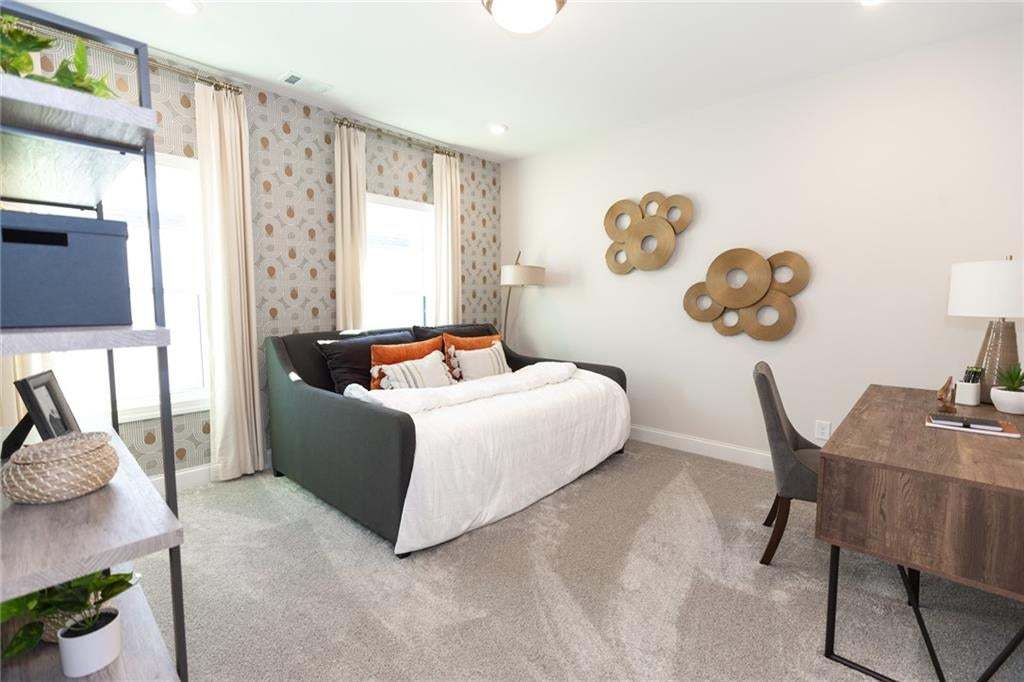 Wall-to-wall carpeting, dual windows with draperies, recessed lighting, and a built-in shelving unit