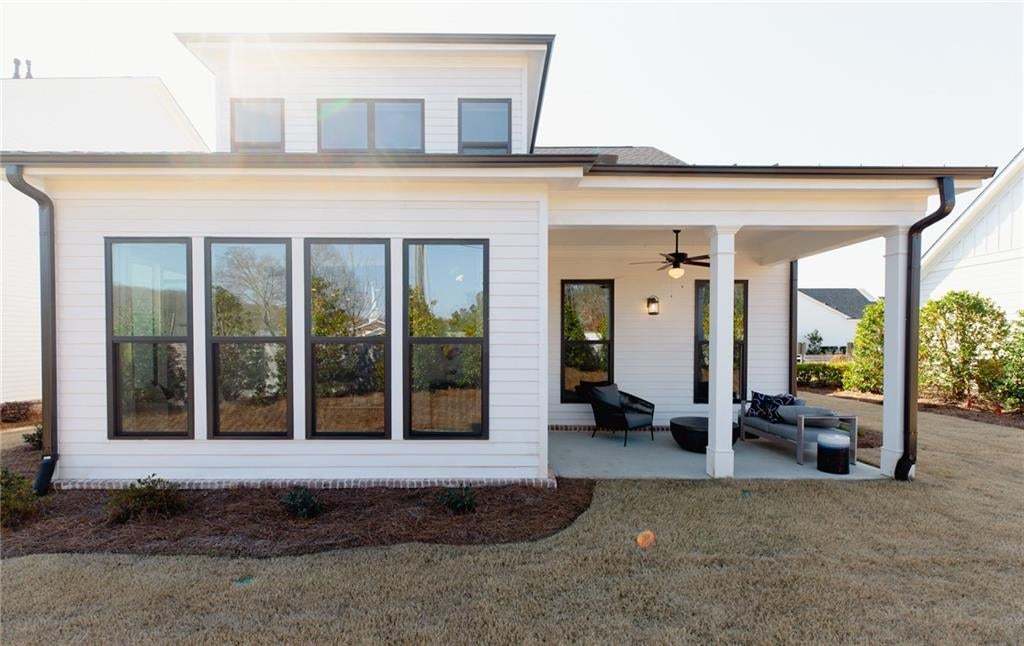 This sunroom provides extra space and the covered porch just finishes the outstanding space. Photo not of actual home but a previously built TPG home of same plan.